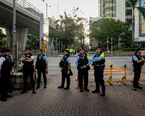 Police officers stand guard outside the West Kowloon courts on Monday ahead of verdict on Jimmy Lai