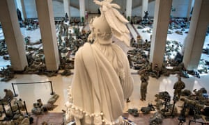 Members of the National Guard rest in the Capitol Visitors Center on Capitol Hill in Washington.