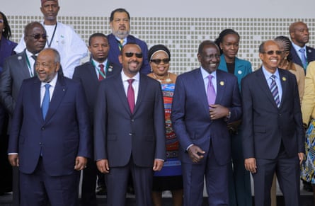 Male and female leaders, mostly in navy suits