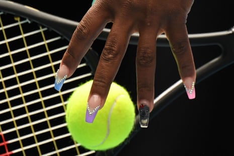 The player's fingernails with a ball and racket