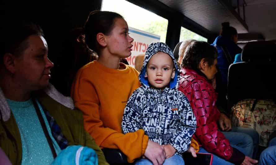 A little boy with his mother and other refugees in an evacuation bus heading from Kramatorsk to Dnipro