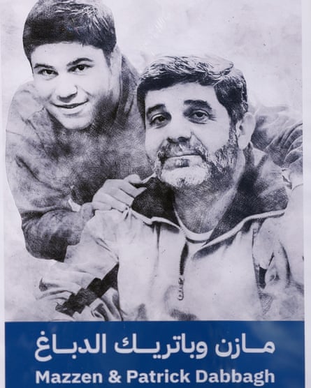 Black and white image of Patrick and Mazzen. Patrick has one hand on his father’s right shoulder and the other is wrapped around his left shoulder