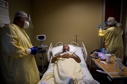 Dr Wilson, left, talks with Covid-19 patient Glen Cowell, a farmer who wasn’t so sure about the virus until it knocked him to his knees.