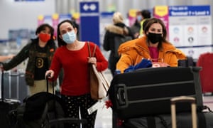 Travellers seen inside the United Airlines terminal at Los Angeles International Airport (LAX) as United Airlines and Delta Air Lines say they have been forced to cancel dozens of Christmas Eve flights.