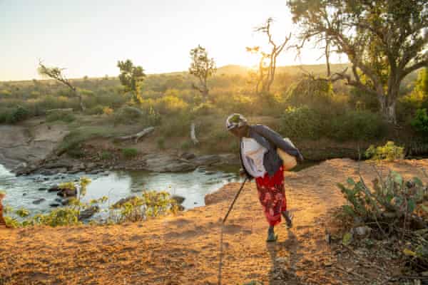 Jecinta Peresia brings back water from the river
