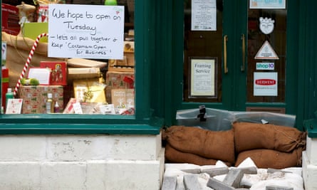 A sign to customers on the window of a business in Cockermouth on Monday