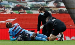 West Ham United's Angelo Ogbonna is treated by medical staff.