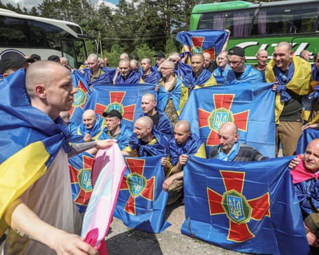 Ukrainian prisoners of war gather after a swap, amid Russia