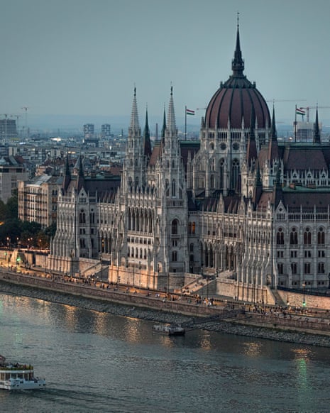 Grand building with numerous turrets and a dome on the banks of the river