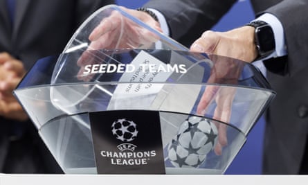 Teams are picked out of a clear container in a Champions League draw.