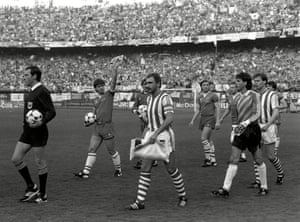 Everton captain Kevin Ratcliffe waves to the crowd as he and his Rapid Vienna counterpart, Hans Krankl, lead out their teams.