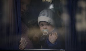 Russia-Ukraine war latest news: Kyiv rejects Moscow’s deadline for Mariupol surrender; Biden to visit Poland – live | World news 4 A refugee woman holds a baby while waiting on a bus for Ukrainian police to check papers and belongings in Brovary, Ukraine