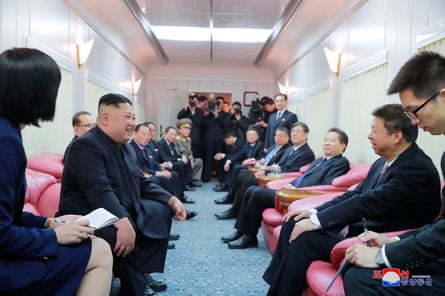 North Korean leader Kim Jong-un, second left, talks with a Chinese official on his train on the way home from China, in 2019.