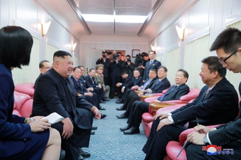 North Korean leader Kim Jong-un, second left, talks with a Chinese official on his train on the way home from China, in 2019.