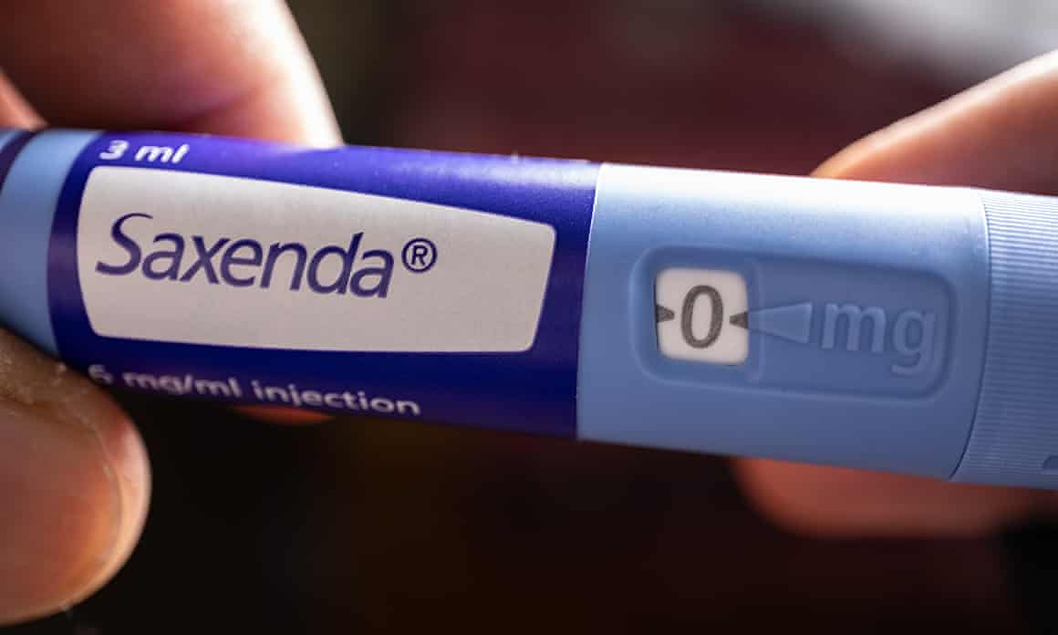 Close-up of someone holding a Saxenda injection pen