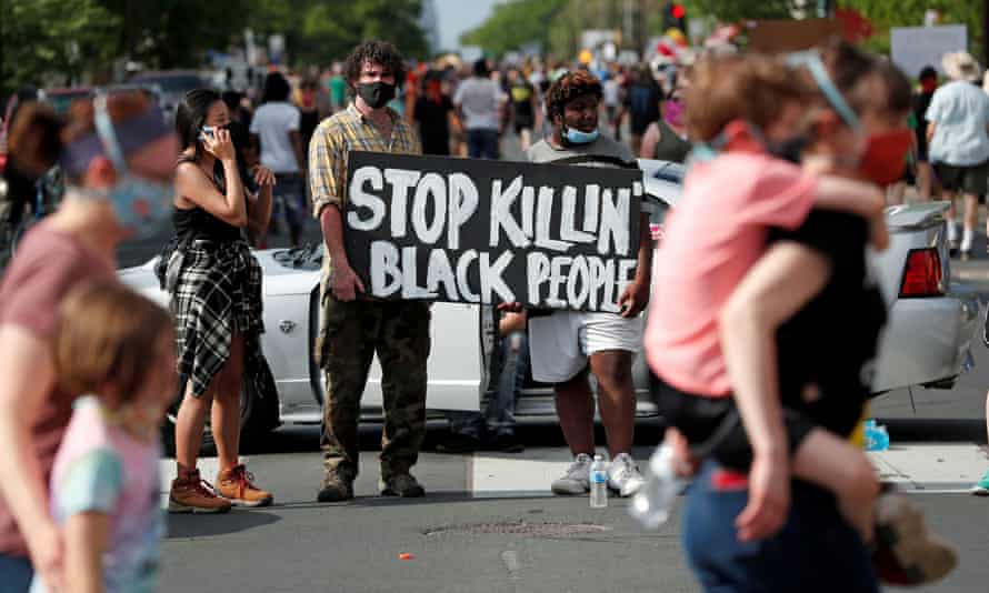 Protesters gather at the scene where George Floyd was pinned down by a police officer kneeling on his neck in Minneapolis, Minnesota, on 26 May.