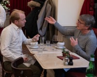 Ruper and Paul eating soup and chatting across a restaurant table