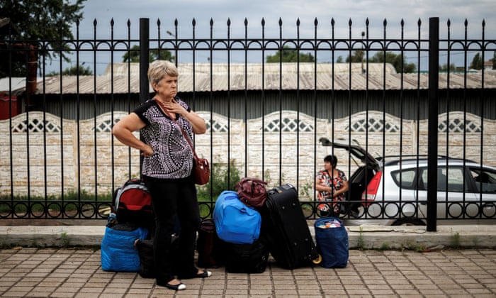 Galina Pryhodko and her sister Iryna, from Bakhmut, wait to board a train in Pokrovsk, Ukraine.