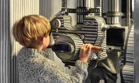 A young boy looks through a film camera at the Karel Zeman Museum in Prague.