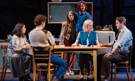 Characters from The House of Shades gather around a table on stage