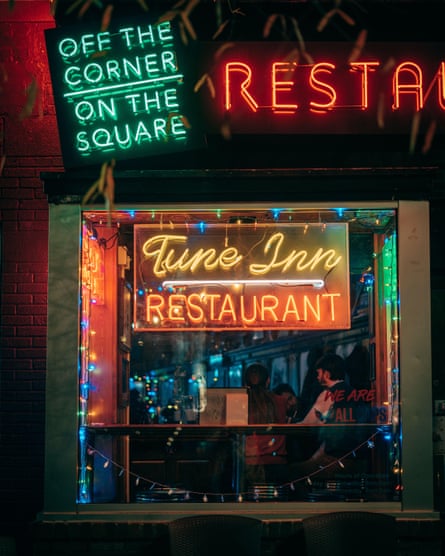 neon signs say ‘tune inn restaurant’ and ‘off the corner on the square’