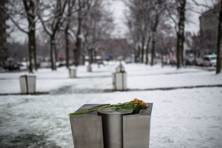 A flower is placed on a commemorative plaque to mark the 25th anniversary of the Ecole Polytechnique massacre in Montreal,