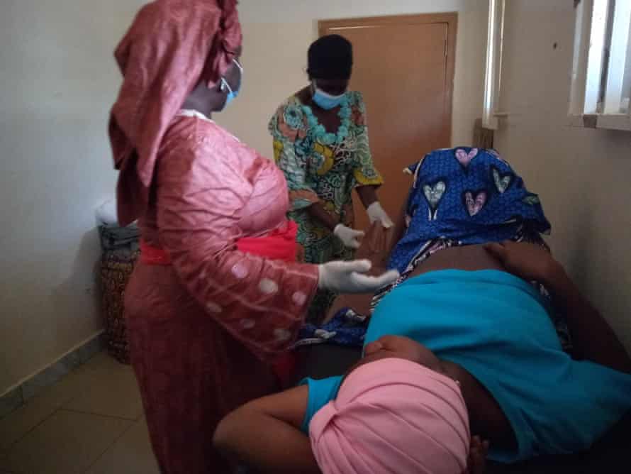 Ayuba and Ali caring for a pregnant woman