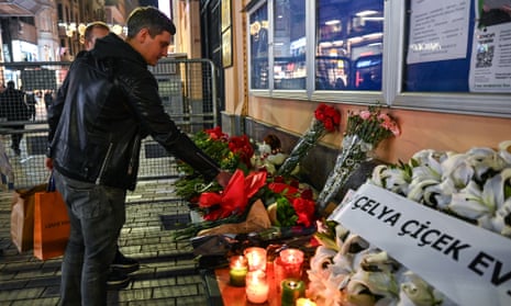 A man lays a flower outside the Russian consulate in Istanbul, Turkey, on March 23, 2024.