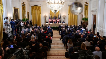 panel of people speak in front of people sitting in rows