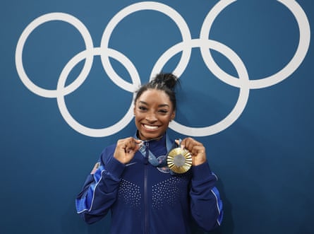 Team USA’s Simone Biles celebrates with her all-around gymnastics medal.