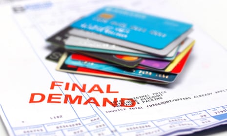Credit cards piled on top of a final demand bill