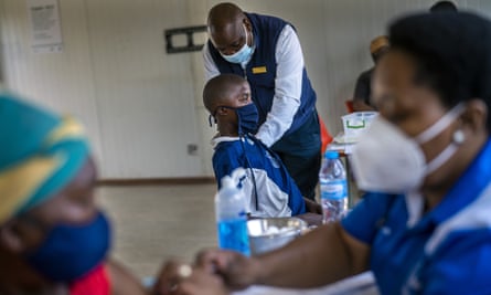 People receive Covid vaccines in Lawley, South Africa.