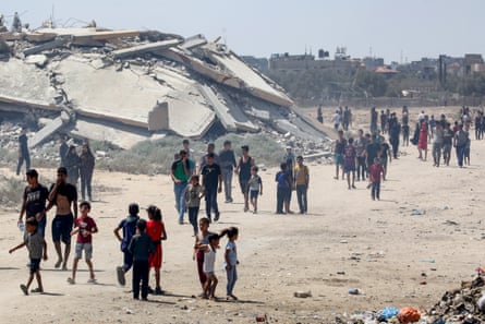 Displaced Palestinians make their way towards the site of a humanitarian aid airdrop at the Bureij camp in Gaza on Sunday.