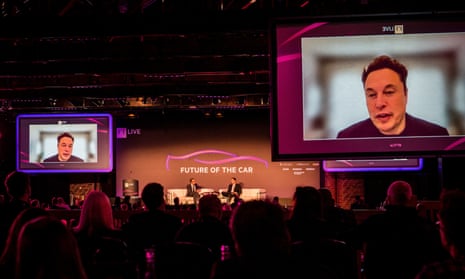 Elon Musk speaking on screen at the Financial Times Future of the Car summit