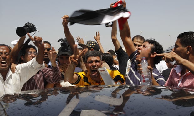 Egyptian protesters react to the news of outsed leader Hosni Mubarak's life sentence in 2012.