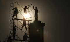 Activists scale a monument in Mexico City to replace a wooden figure with a more permanent version made of steel.