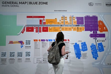 An attendee checks the map at the facility hosting Cop30
