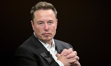 Elon Musk clasping his hands.