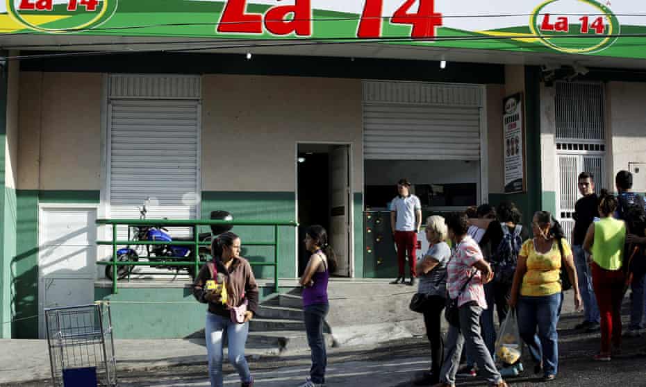 A supermarket with its security shutters partially closed as a precaution against looting in San Cristobal.