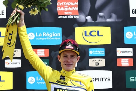 Vingegaard cracks a smile while standing atop the podium