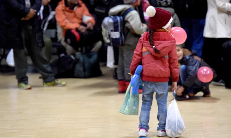Migrants wait to board a ferry to Sweden from Kiel, Germany. 