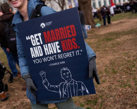 A woman carries a sign with a quote from Charlie Kirk during the annual March for Life, 23 January 2026.