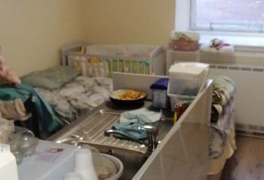 A cooker, sink, bed and cot often crammed into one tiny room.