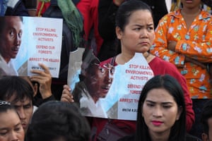 Boeng Kak community land rights activists in Phnom Penh, Cambodia, hold up a poster of environmental activist Chut Wutty