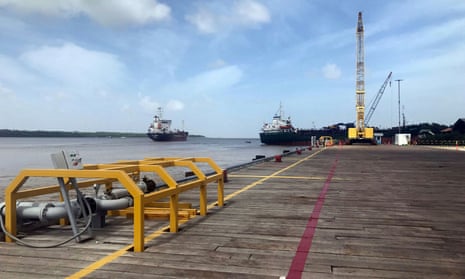 Ships carrying supplies for an ExxonMobil offshore oil platform leave the Demerara river south of Georgetown, Guyana.