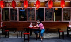 A person uses her mobile phone outside a restaurant in Taipei, Taiwan 14 May 2024