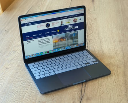 The MacBook Neo open showing the Guardian website.