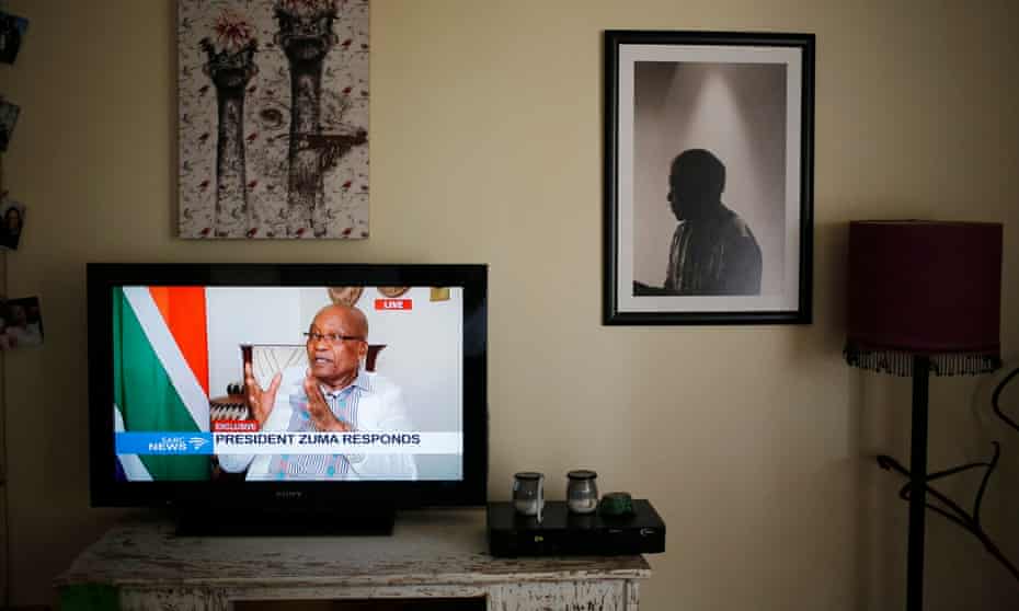 The South African president, Jacob Zuma, appearing on state TV with a portrait of Nelson Mandela to the right of the picture