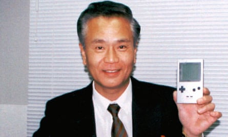 Gunpei Yokoi, who designed Nintendo’s world-famous Game Boy, poses with his product in 1996