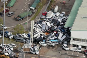 Vehicles are left piled in a heap in Kobe